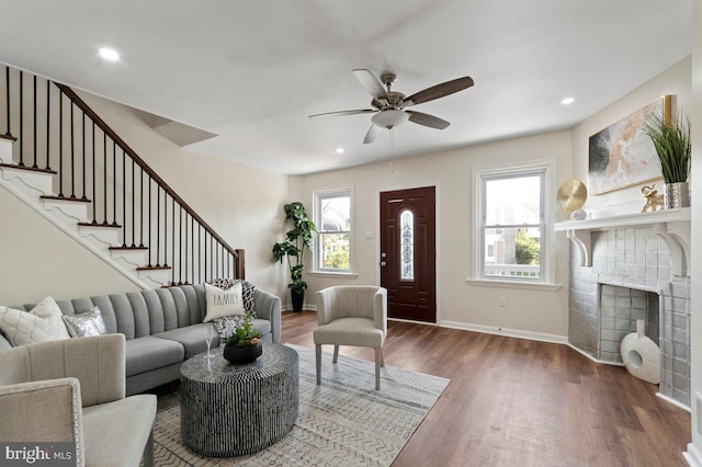 living room with dark hardwood / wood-style floors and ceiling fan