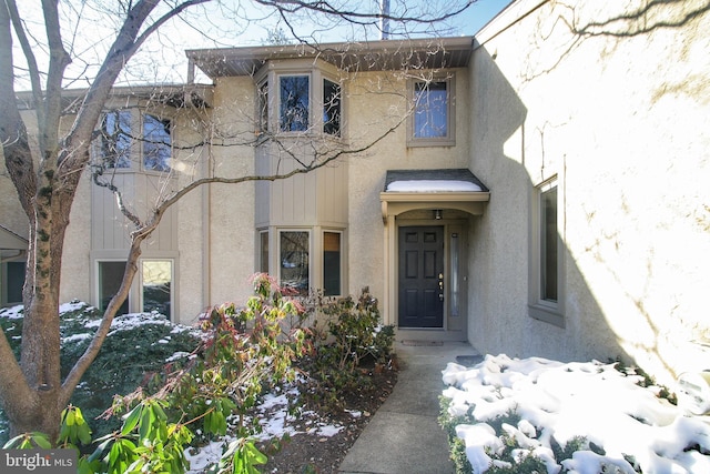 view of snow covered property entrance