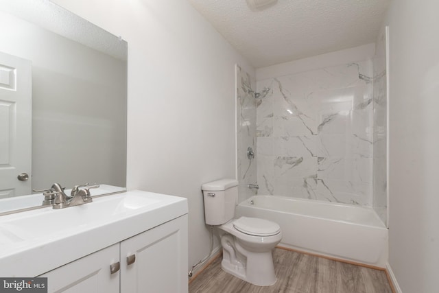 full bathroom with tiled shower / bath combo, wood-type flooring, a textured ceiling, toilet, and vanity