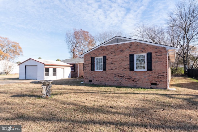 view of front facade featuring a garage, an outbuilding, and a front yard