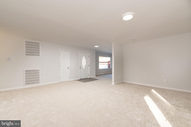 117 N Virginia Ave, Richmond, VA 23223 - unfurnished living room featuring light colored carpet, baseboards, and recessed lighting