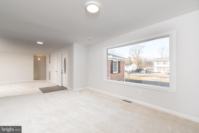 spare room featuring light colored carpet