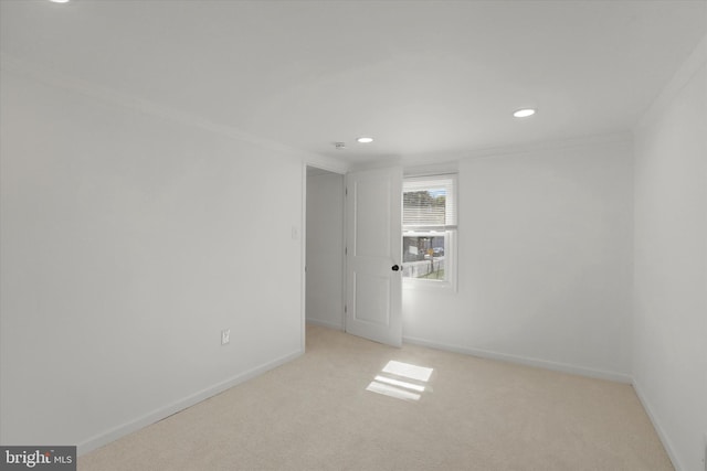 carpeted spare room with crown molding