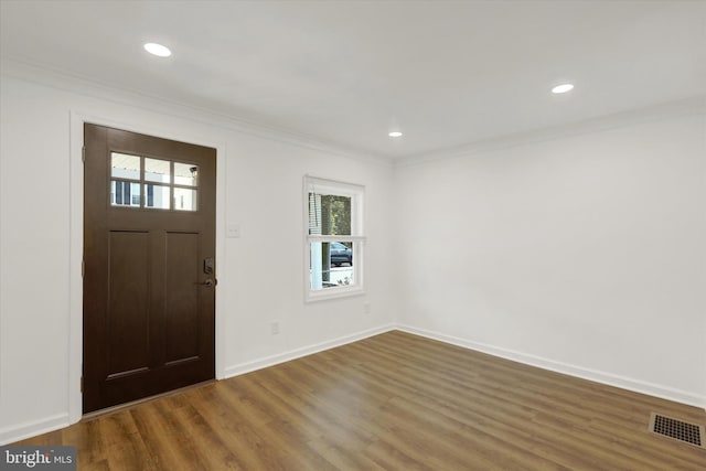 entrance foyer with crown molding and wood-type flooring