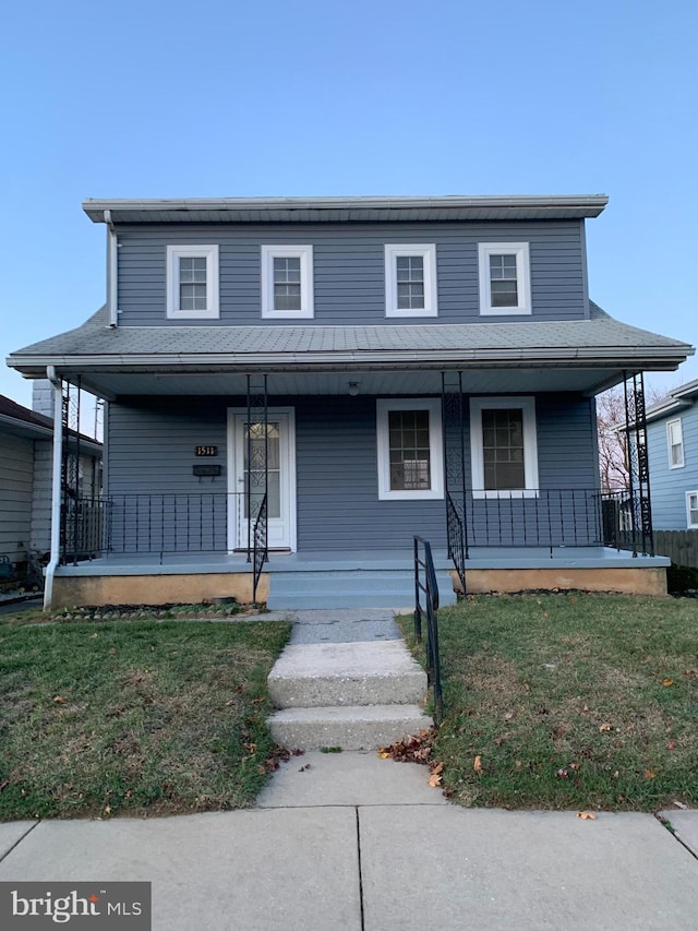 view of front of home with a front yard and a porch