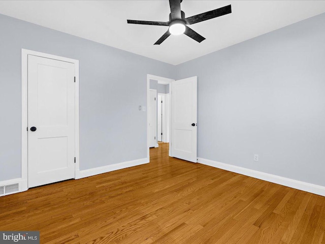 spare room with ceiling fan and wood-type flooring