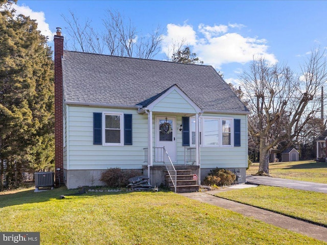 bungalow-style home with a front yard and central AC