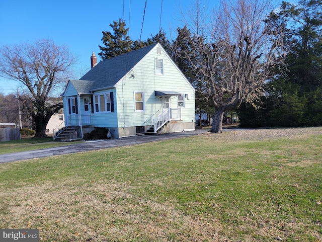 view of side of home with a yard