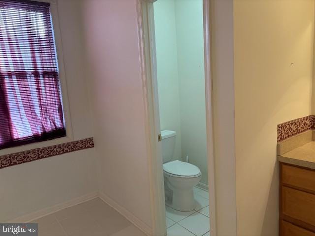 bathroom with tile patterned floors, vanity, and toilet