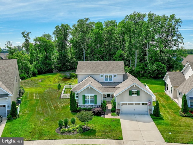 craftsman house with a front lawn and a garage