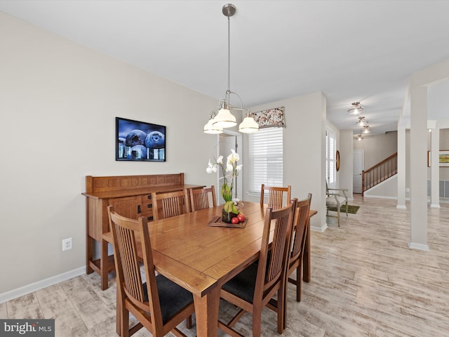 dining room with a chandelier and light hardwood / wood-style flooring