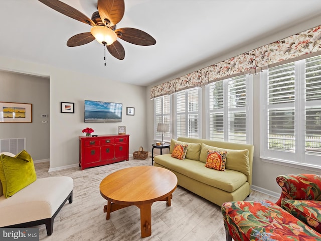 living room featuring ceiling fan and light wood-type flooring