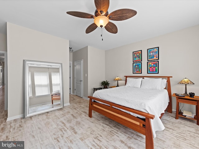 bedroom with ceiling fan and light hardwood / wood-style floors