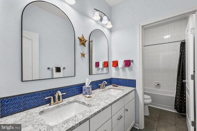 full bathroom with vanity, tile patterned flooring, toilet, tasteful backsplash, and shower / tub combo