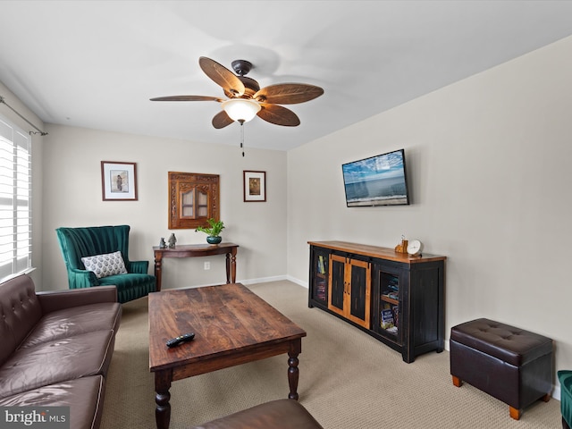 carpeted living room with ceiling fan