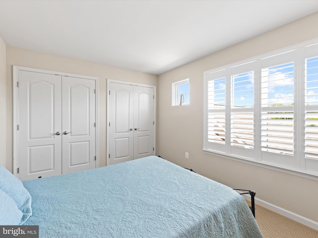 carpeted bedroom with two closets