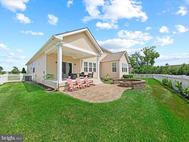 rear view of property with a patio area, a yard, and central air condition unit