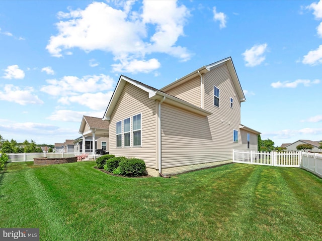 view of home's exterior with a lawn