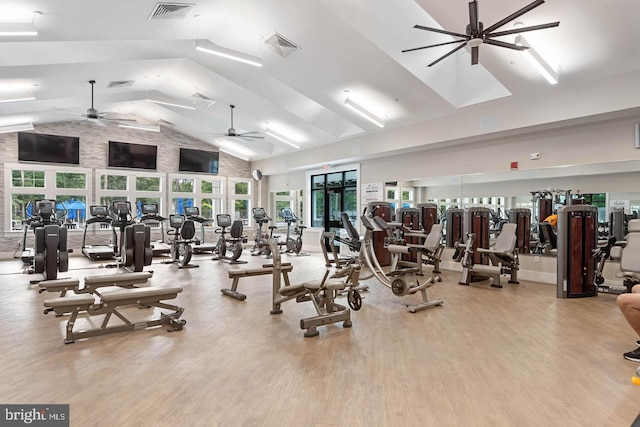 workout area featuring ceiling fan, high vaulted ceiling, and light wood-type flooring