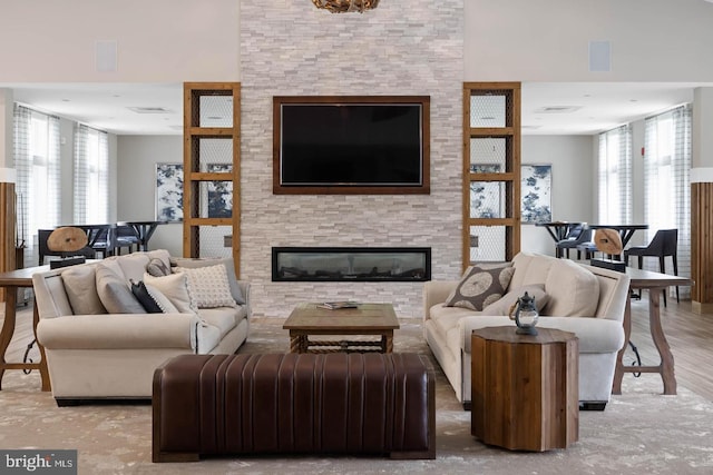 living room with a fireplace, hardwood / wood-style flooring, and a healthy amount of sunlight