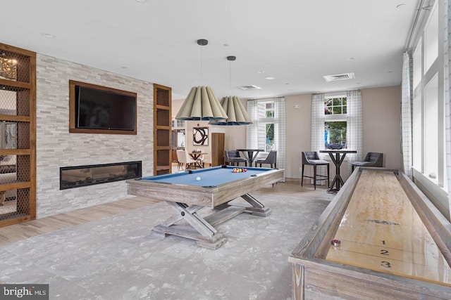 playroom with a fireplace, hardwood / wood-style flooring, a healthy amount of sunlight, and pool table