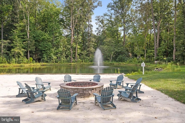 view of patio featuring a water view and an outdoor fire pit