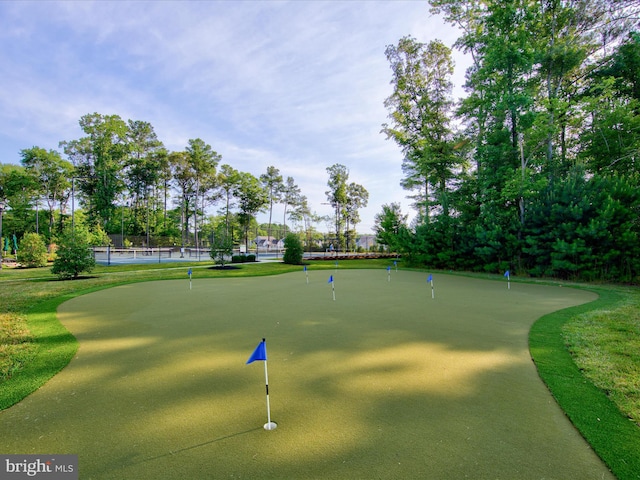 view of property's community featuring tennis court