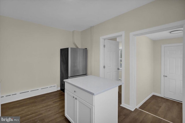 kitchen featuring white cabinets, dark wood-type flooring, and a baseboard heating unit