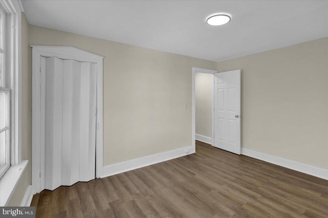 spare room featuring wood-type flooring