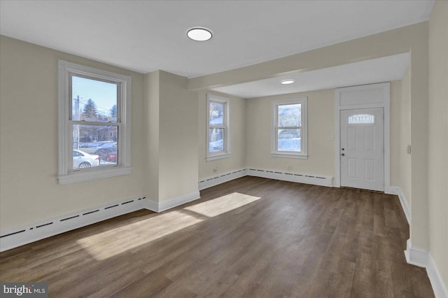 entrance foyer with baseboard heating and dark hardwood / wood-style flooring