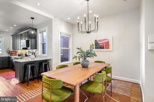 dining area with a chandelier, light hardwood / wood-style flooring, and plenty of natural light