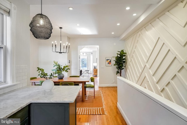 interior space with a notable chandelier and light wood-type flooring