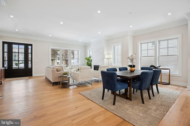 dining room featuring crown molding and light hardwood / wood-style flooring