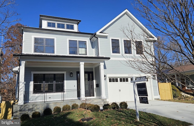 view of front facade featuring a porch and a garage