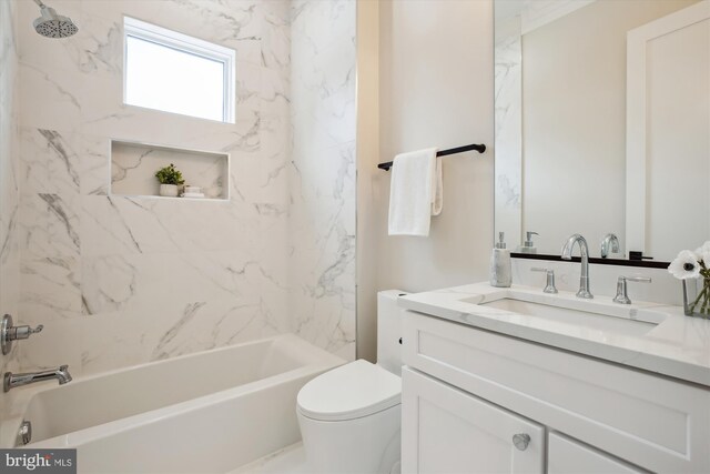 full bathroom with toilet, vanity, and tiled shower / bath combo