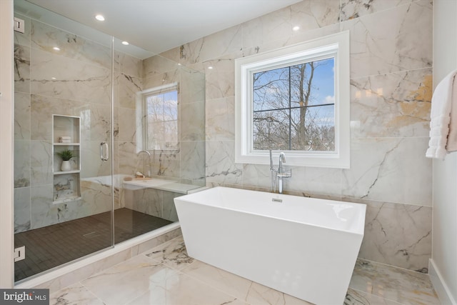 bathroom with tile walls and plus walk in shower