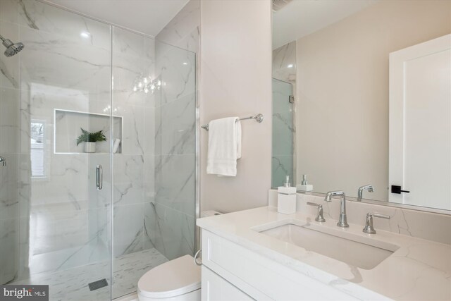 bathroom with toilet, an enclosed shower, and vanity