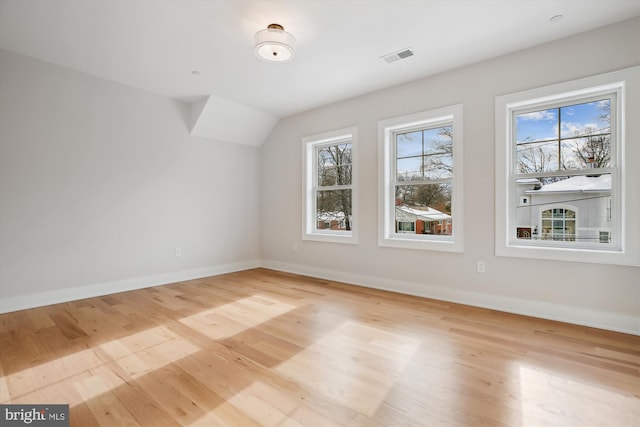 bonus room featuring vaulted ceiling and light hardwood / wood-style floors