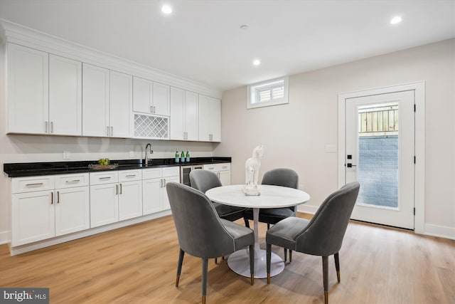 dining space featuring sink and light wood-type flooring