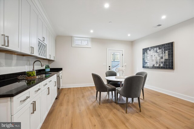 dining area with light hardwood / wood-style floors and sink