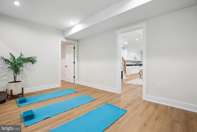 workout area featuring sink and hardwood / wood-style floors