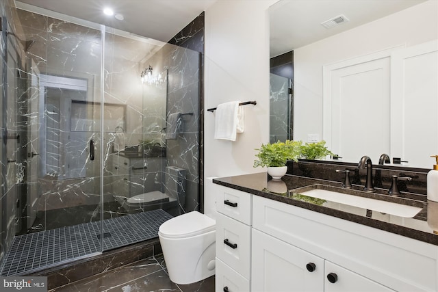 bathroom with toilet, a shower with door, and vanity