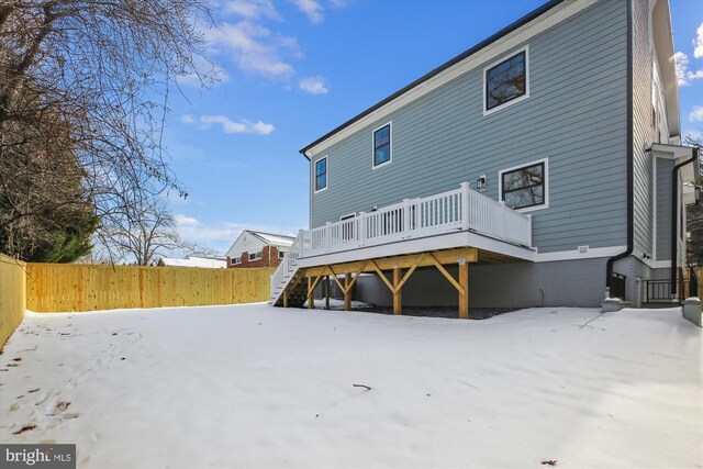 snow covered property featuring a deck