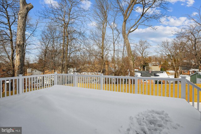 snowy yard with a wooden deck