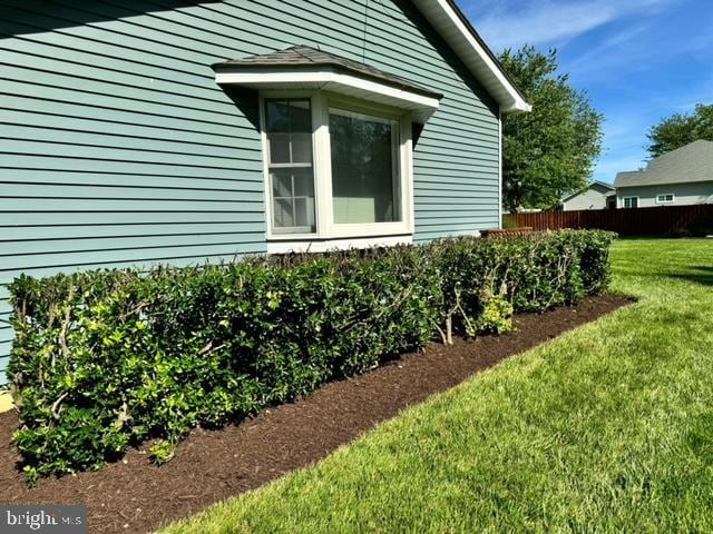 view of side of property with a lawn