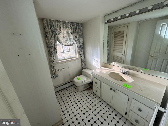 bathroom with vanity, toilet, and baseboard heating