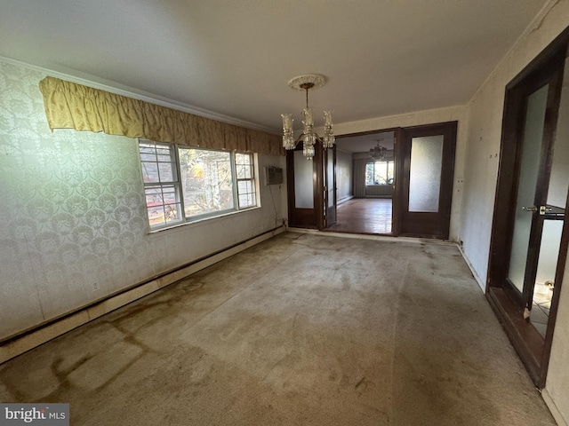 interior space featuring carpet flooring, a notable chandelier, a healthy amount of sunlight, and ornamental molding