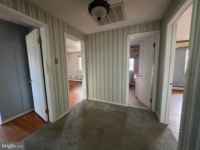 hallway featuring dark hardwood / wood-style floors and a baseboard heating unit