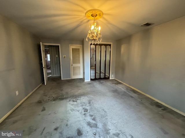 unfurnished room with dark carpet and an inviting chandelier