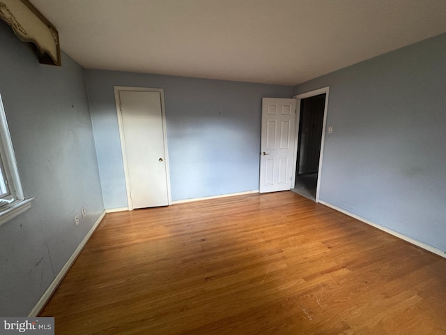 unfurnished room with light wood-type flooring